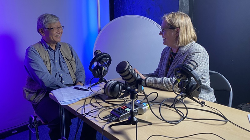 Andrew Sheng and Evelyn Welch sat at a table recording a podcast episode